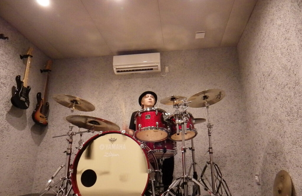 A professional musician and drummer, performing in his home studio.