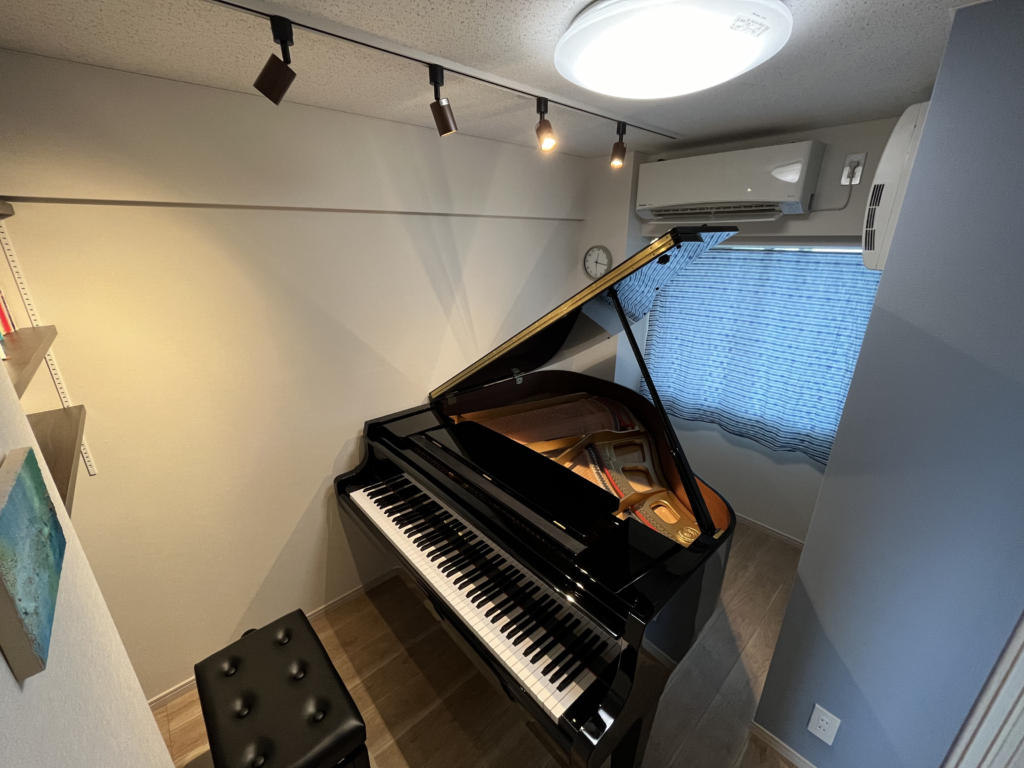Photograph of a finished soundproof room with a grand piano installed.